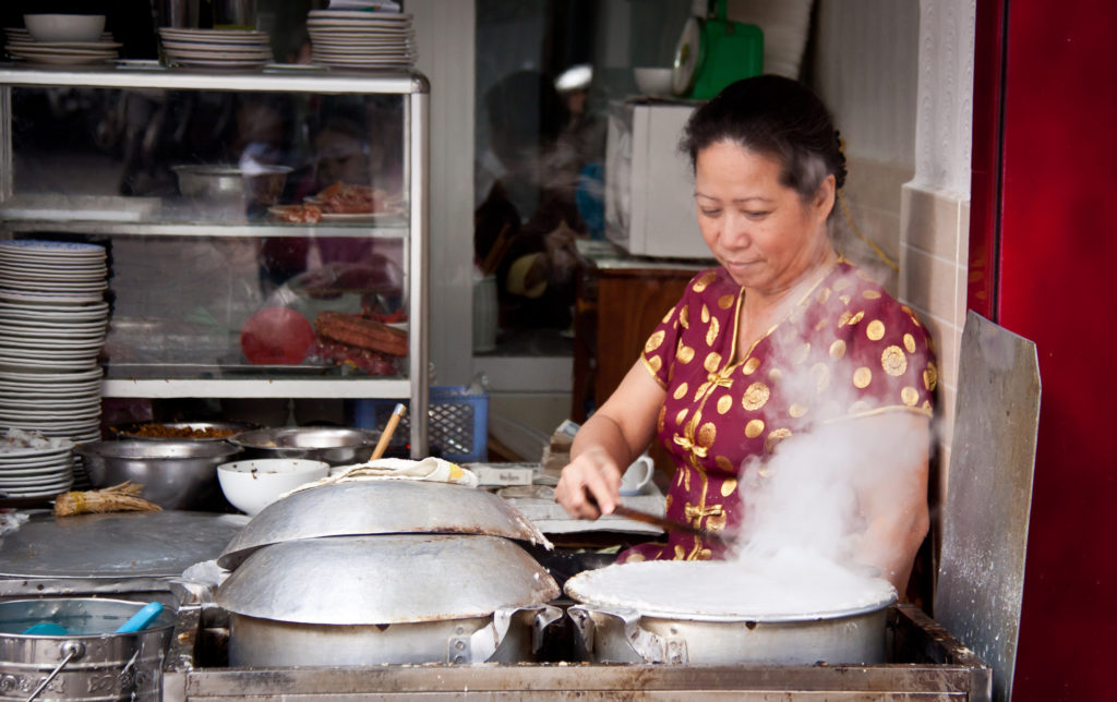 Woman preparing Banh Cuon