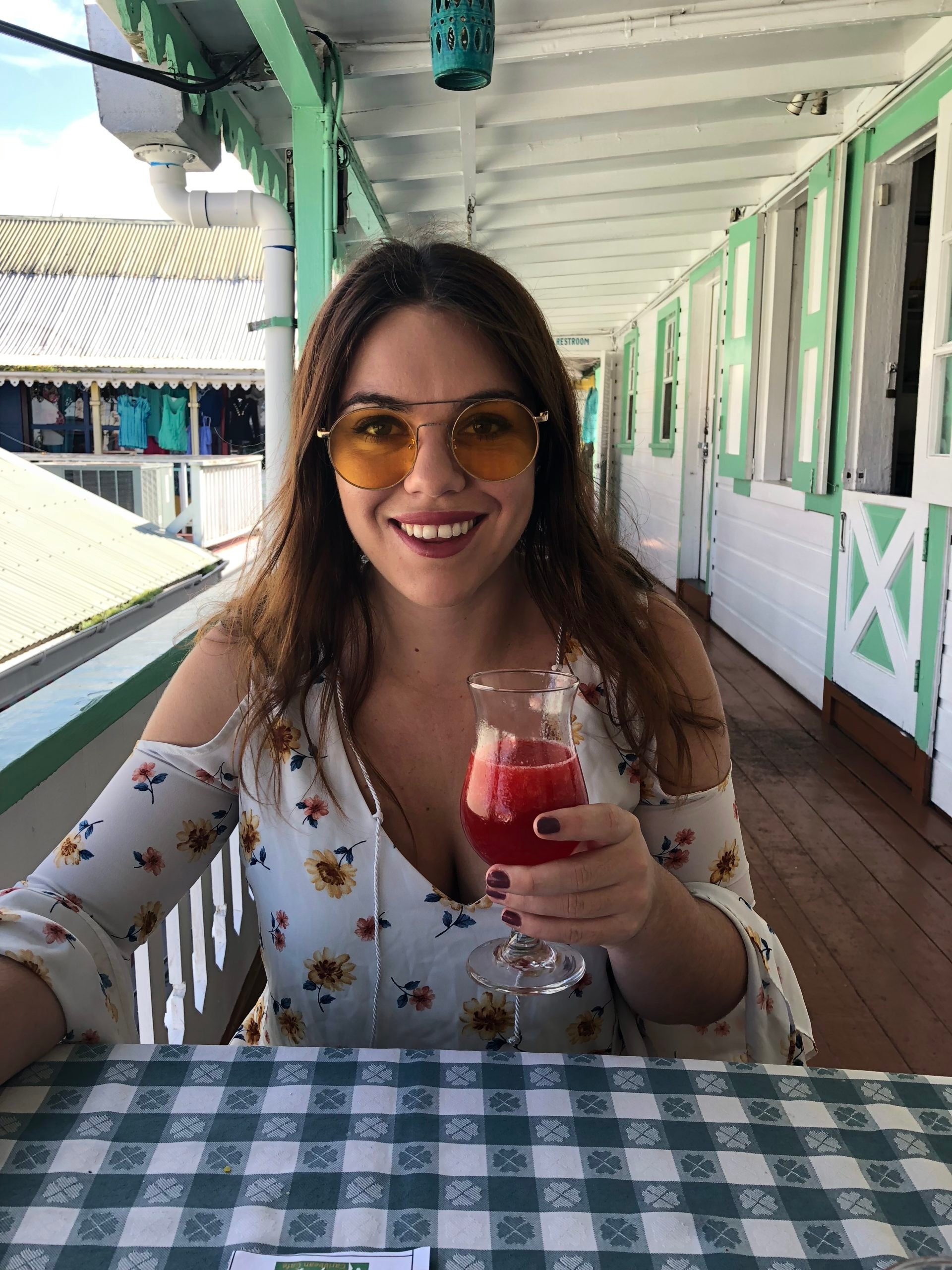 woman holding drink at table