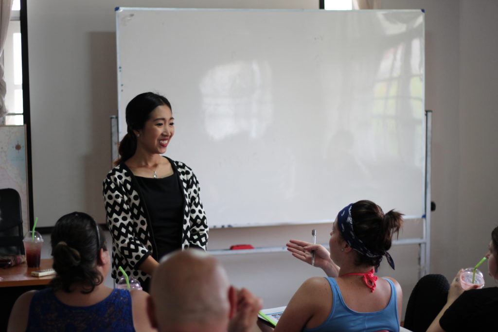 A Thai language teacher teaching English speakers how to speak Thai