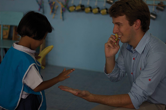 Liam congratulating one of his kindergarten pupils when teaching English in Thailand in 2012