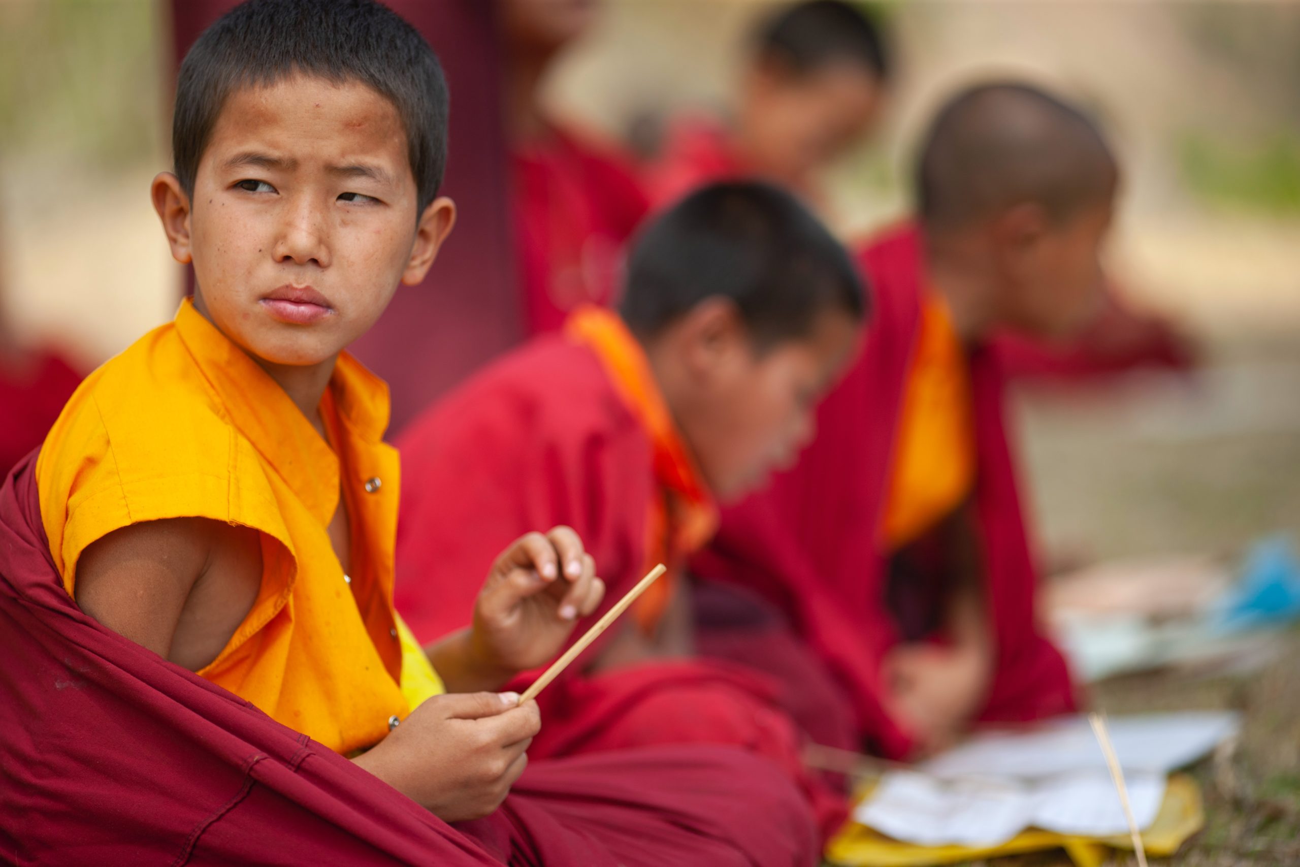 young buddhist monks in robes