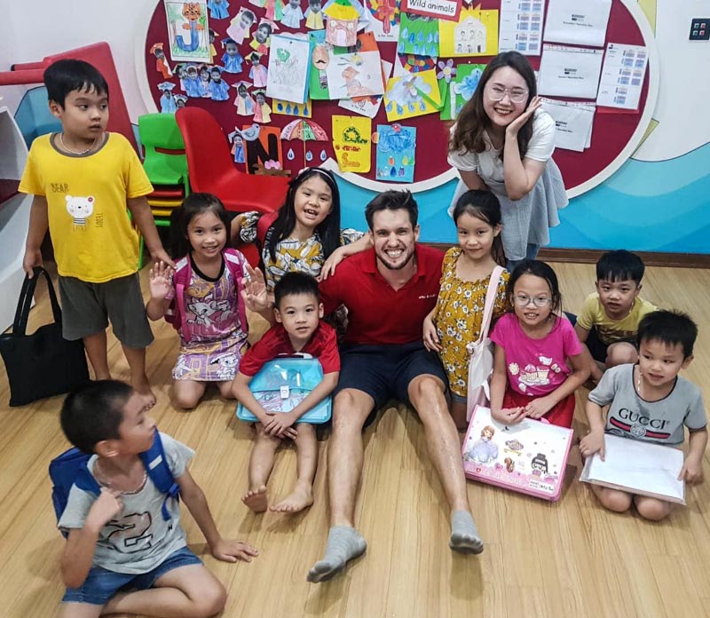 Man in classroom with Vietnamese students