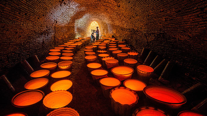 A tunnel of fire and clay: ceramic pots glow inside a traditional kiln in Myanmar.