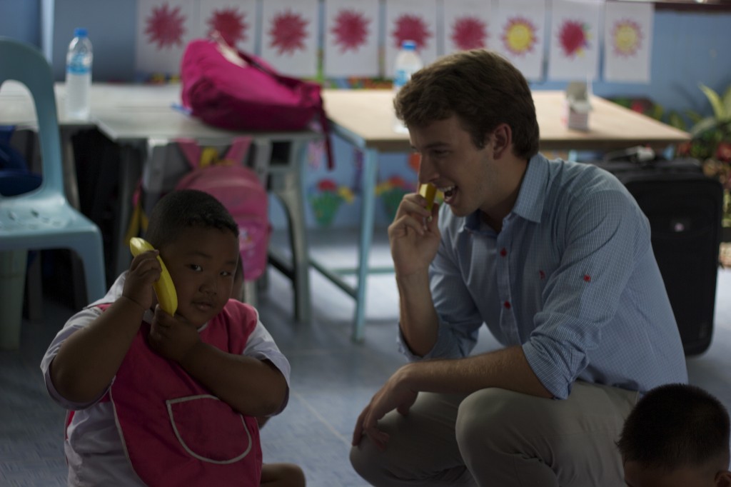 Teacher plays a game of telephone with one of his Thailand pupils