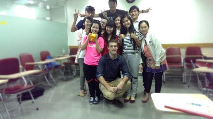 Justin, a videographer from South Africa, at a language institute in Vietnam. Here he is with his young class.