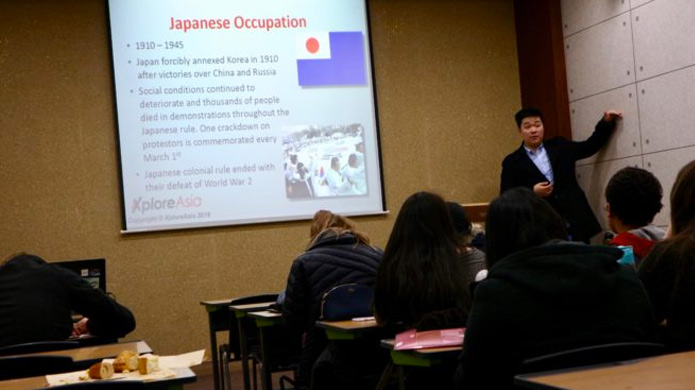 Instructors give a presentation at the South Korea TEFL class