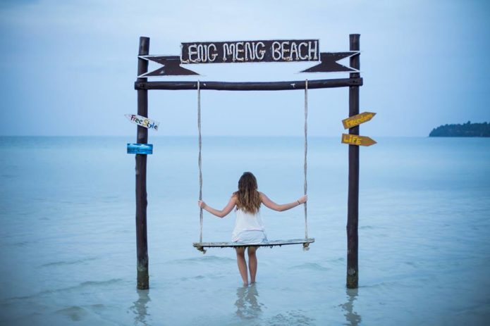 Swinging on a a beach swing on a magical island.