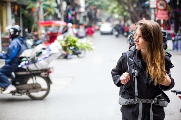 Girl walking through old quarter of hanoi, Vietnam.,
