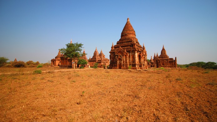 A dry field in Bagan with temples in the background