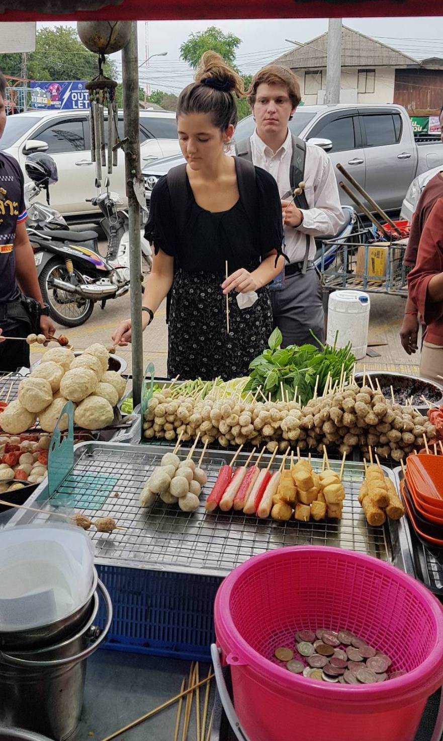 English teachers trying out isaan food at a market in Thailand