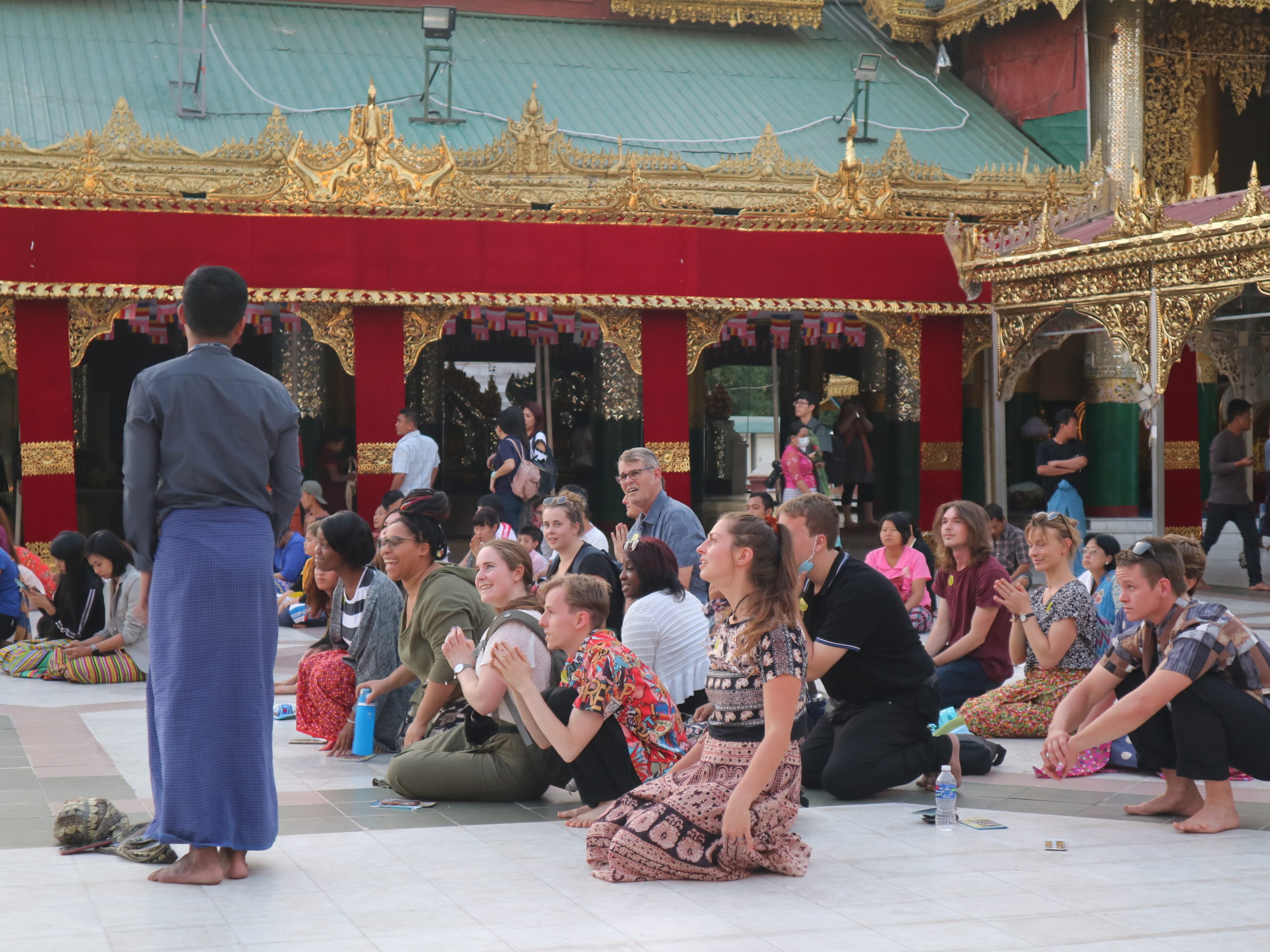 tourists at pagoda kneel down