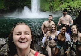 friends standing in front of waterfall